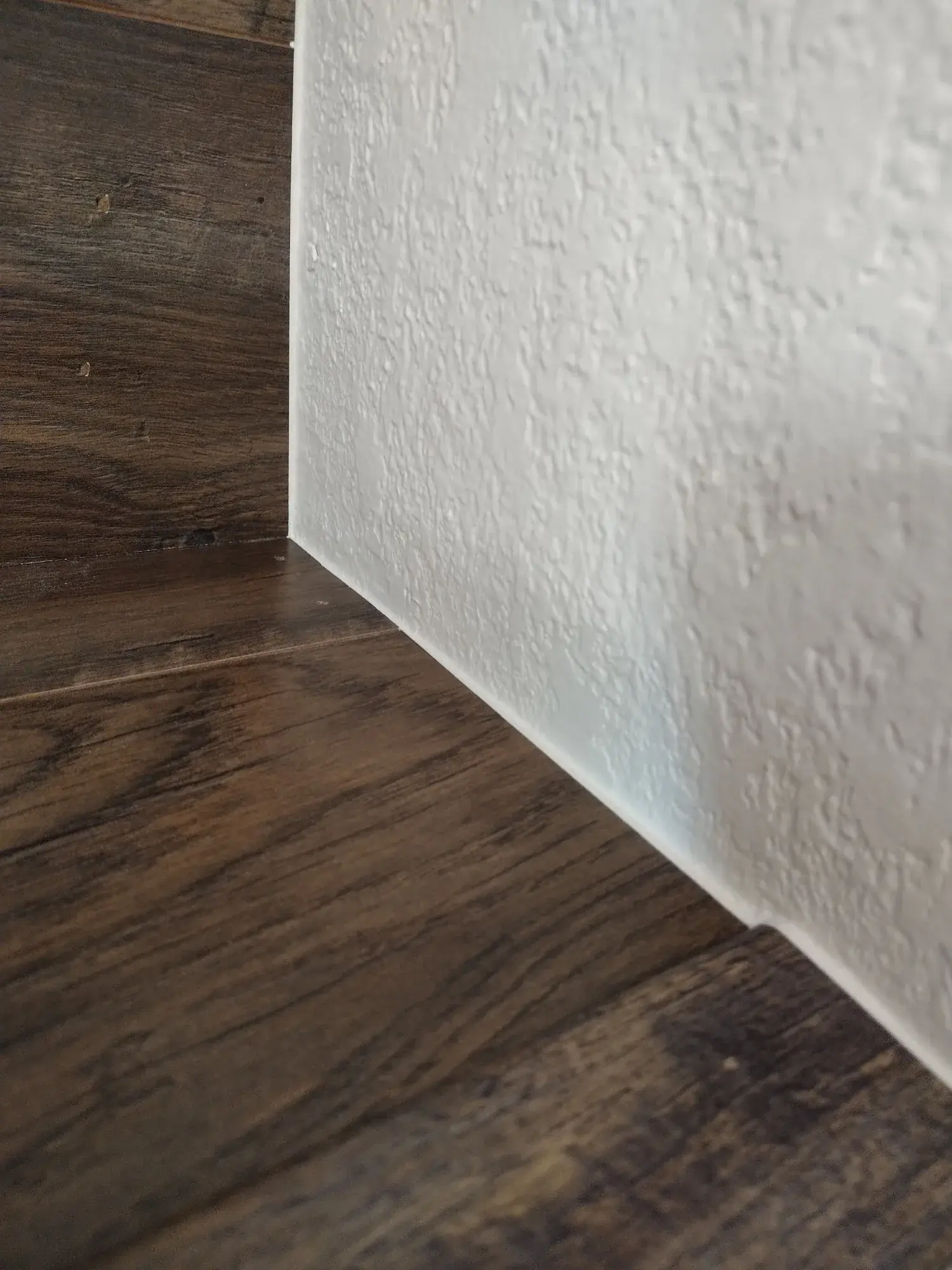 Clean painted wall and baseboard finish detail from Mach Paint Co.