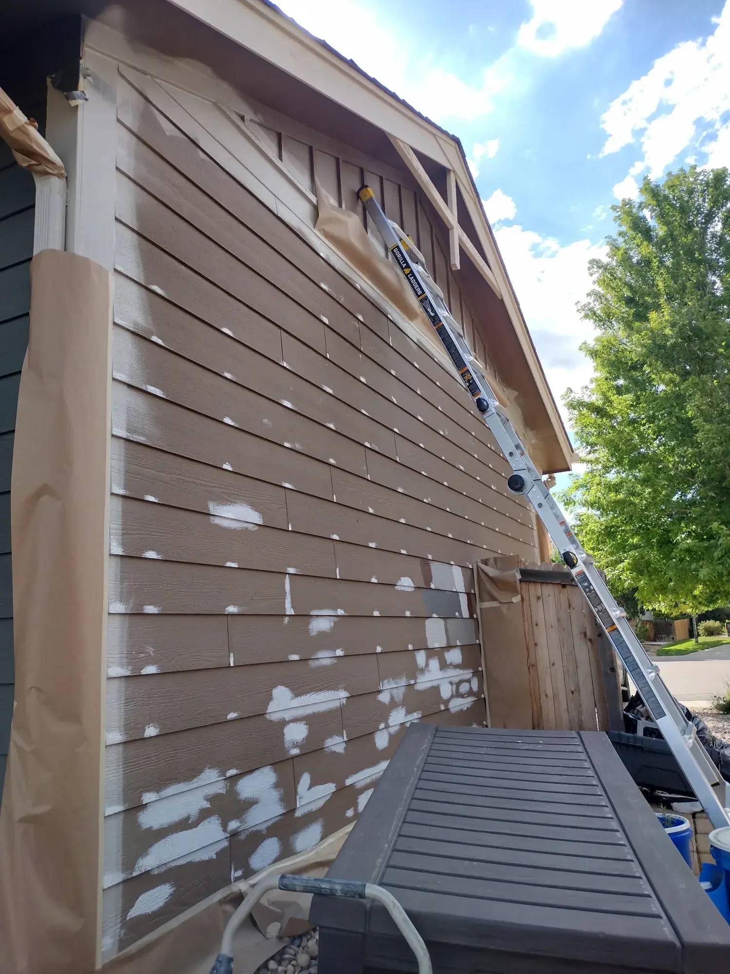 Exterior siding carefully patched and masked during preparation work