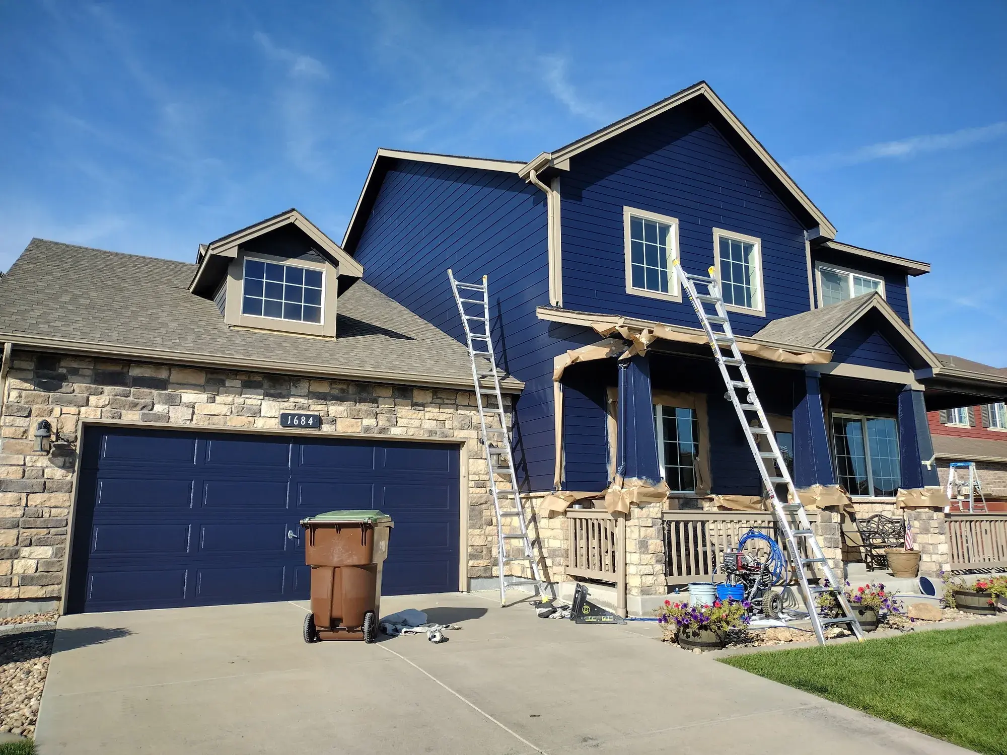 Blue house exterior during preparation and painting work