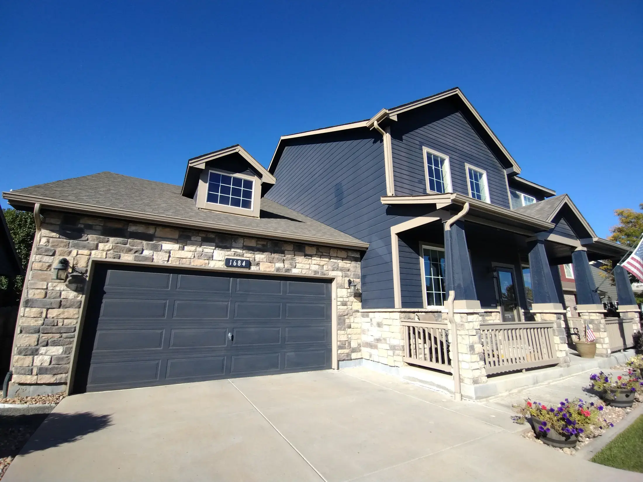 Finished blue residential exterior with contrasting trim and stone
