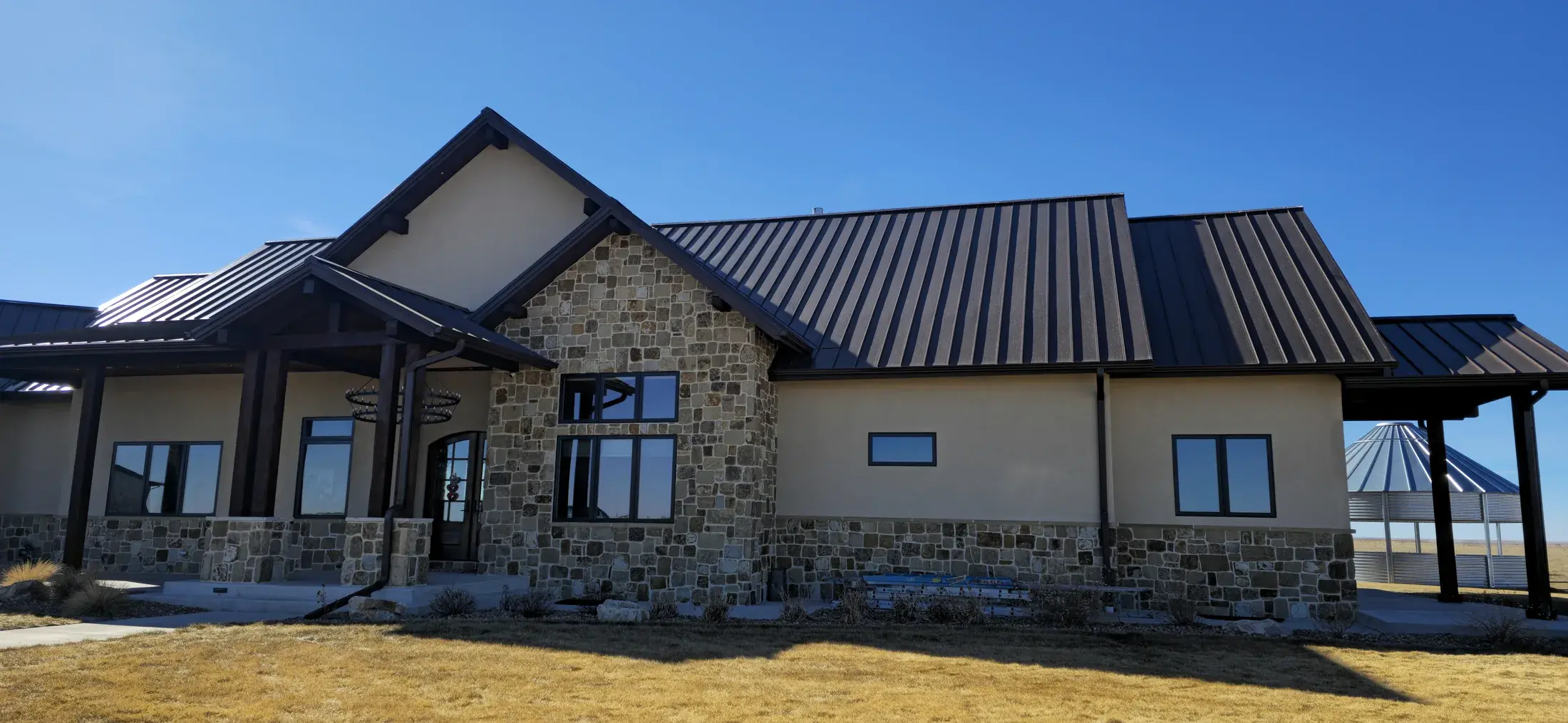 Front elevation of a custom home with stone and painted exterior surfaces