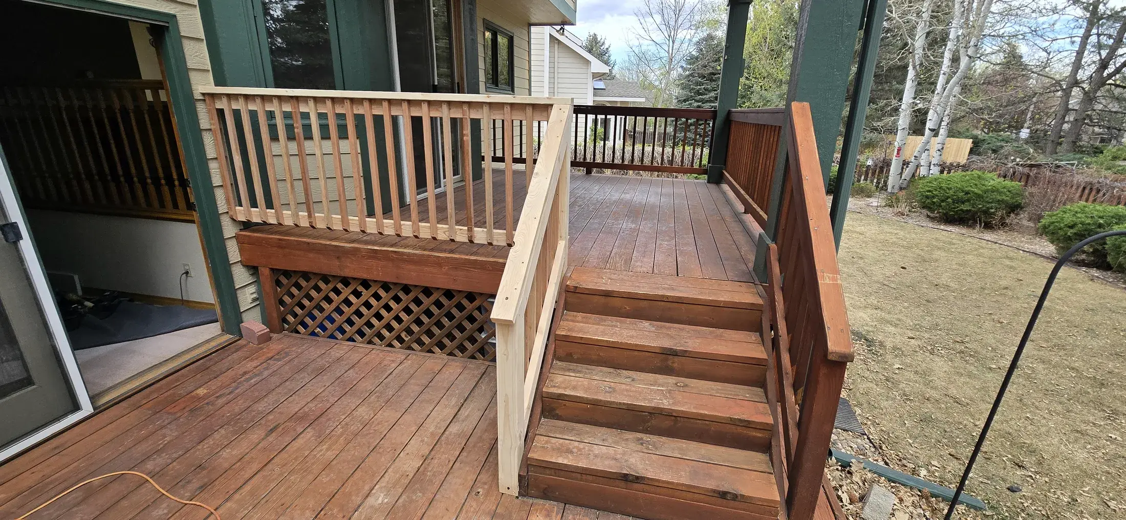 Residential wood deck with railing repair and finish work in progress